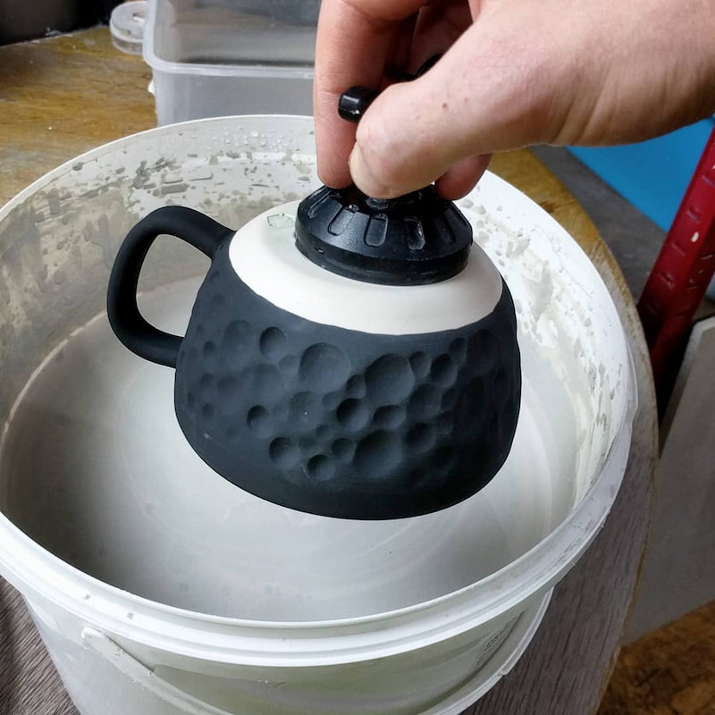 person putting glaze on